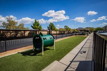 A playground with a green slide and a white sign on it.