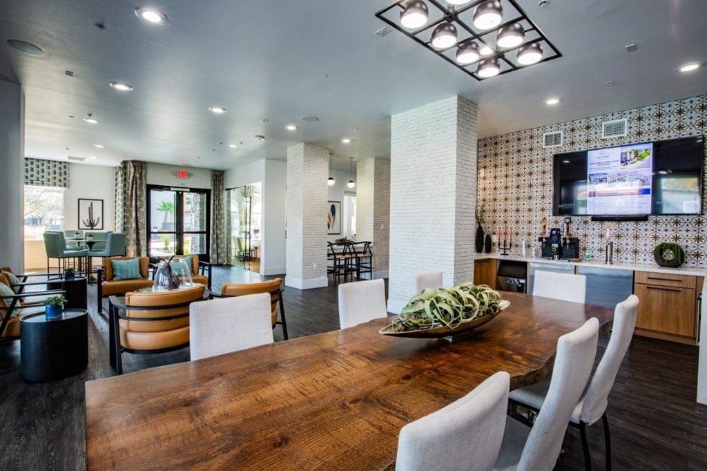 Colton Apartments dining area with chairs and long wooden table