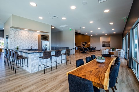 A modern dining room with a wooden table and chairs.