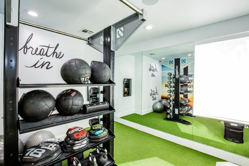 Colton Apartments free weights with mirror in fitness area