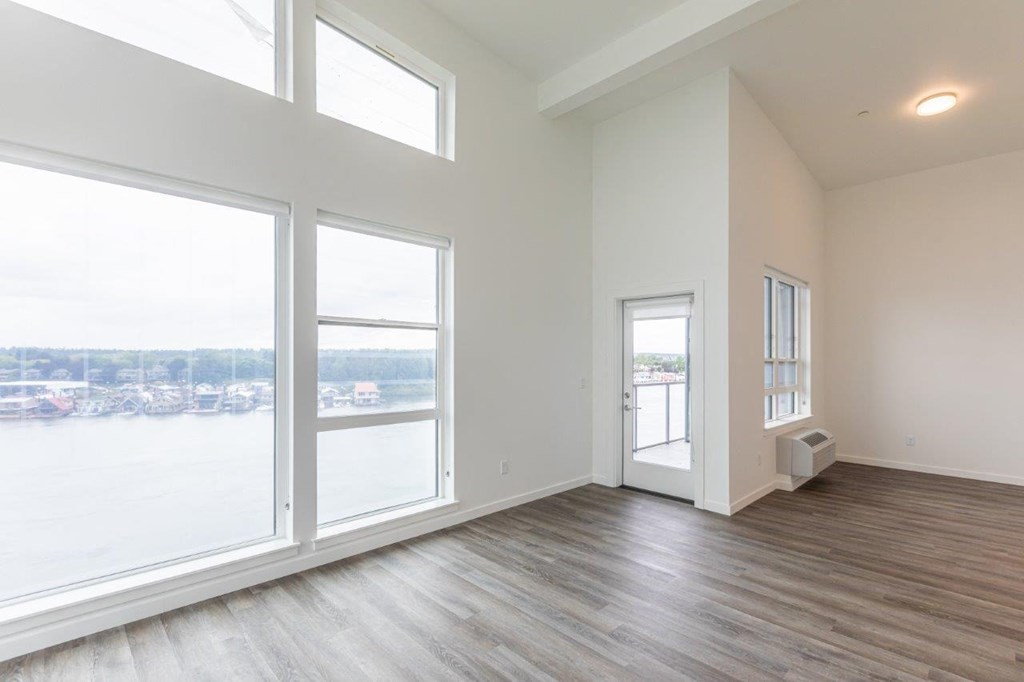 Harbor Sky Living Room with Large Windows and Private Balcony