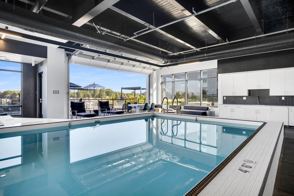 A large indoor swimming pool with a glass bottom.
