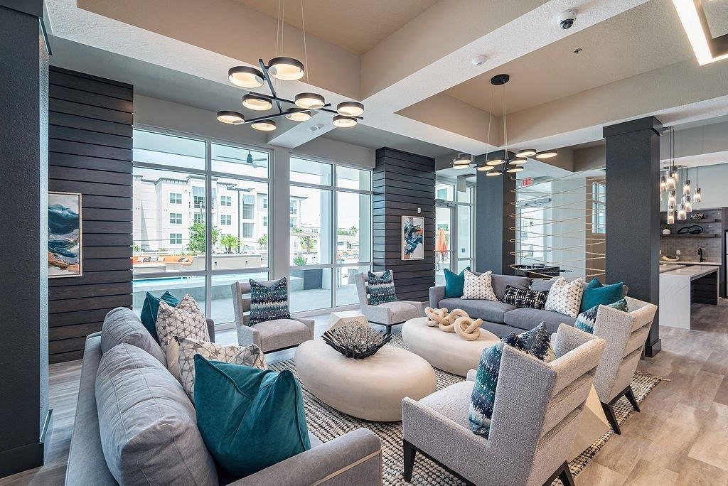 a living room filled with furniture and a large window