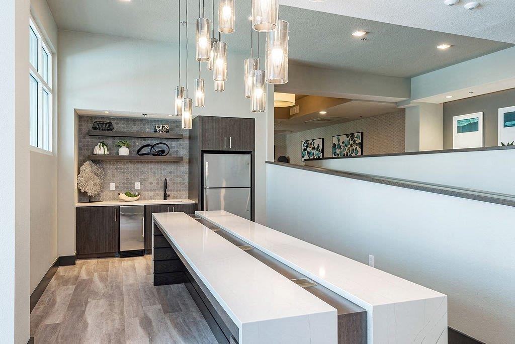 a kitchen with a long counter and a sink