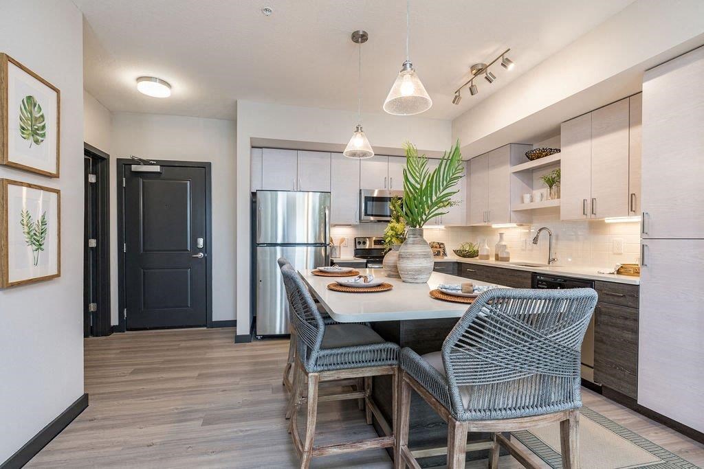 a kitchen with a table and chairs and a refrigerator