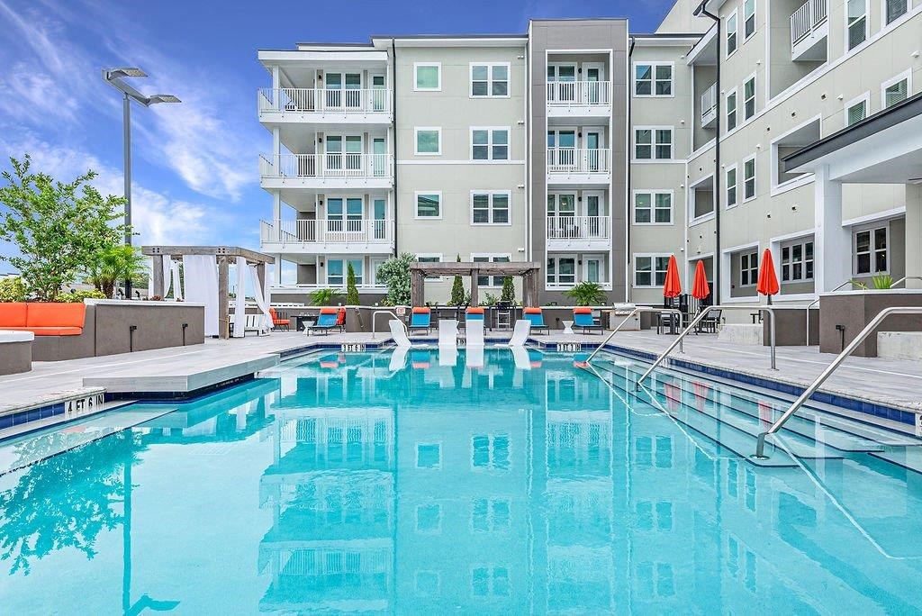 a swimming pool with a building in the background