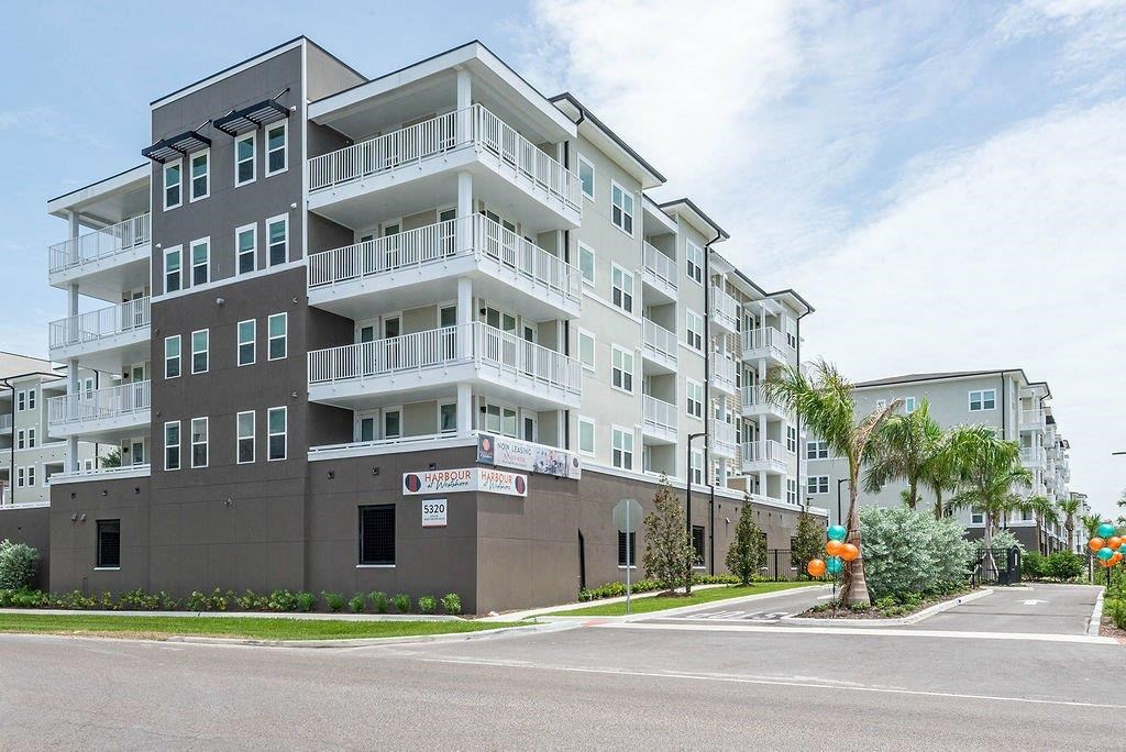 a large apartment building with a sign in front of it