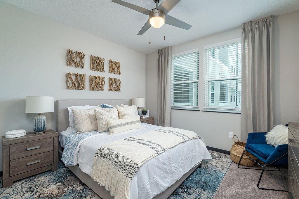 a bedroom with a bed and a ceiling fan