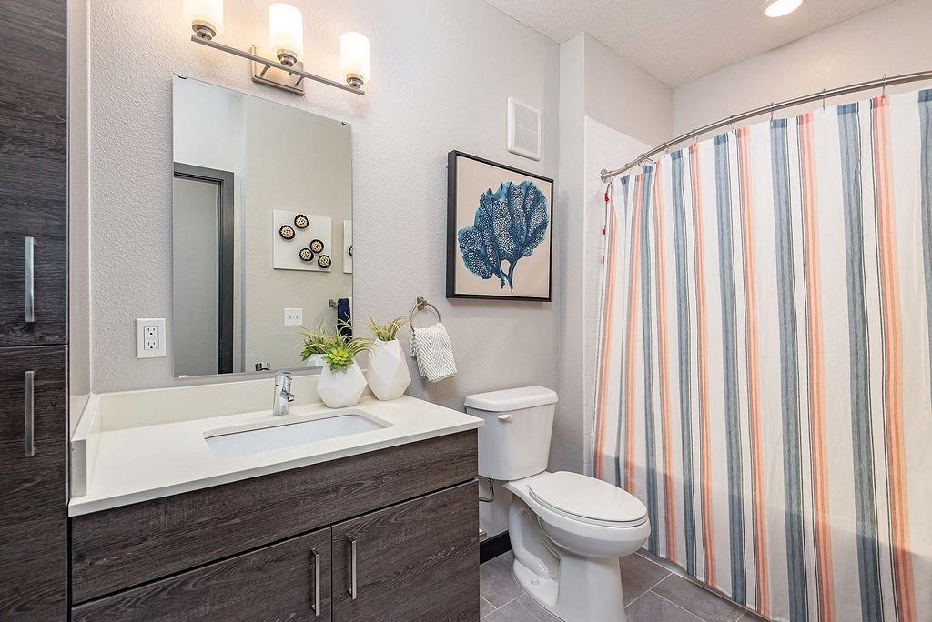 a bathroom with a toilet sink and shower