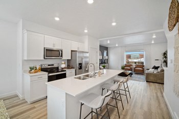 a kitchen with a large center island next to a stove top oven - Photo Gallery 11