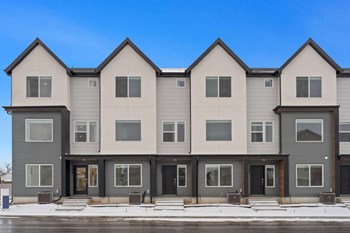 a row of apartment buildings with a blue sky in the background - Photo Gallery 23