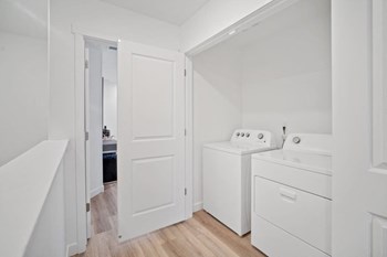 a small laundry room with a washer and dryer - Photo Gallery 17