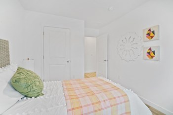 a bedroom with a bed and two doors - Photo Gallery 12