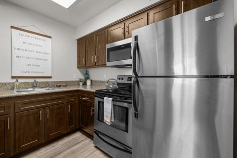 a kitchen with stainless steel appliances and wooden cabinets
