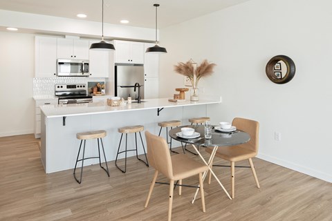 an open kitchen and dining area with a table and chairs