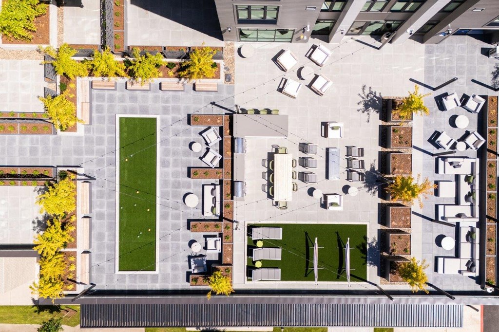 arial view of a campus with a football field and grass
