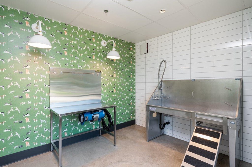a laundry room with a sink and a metal table