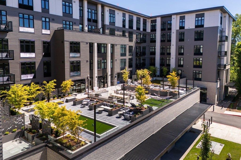 an aerial view of a courtyard with trees and buildings