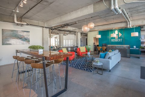 A modern office space with a bar area and seating.