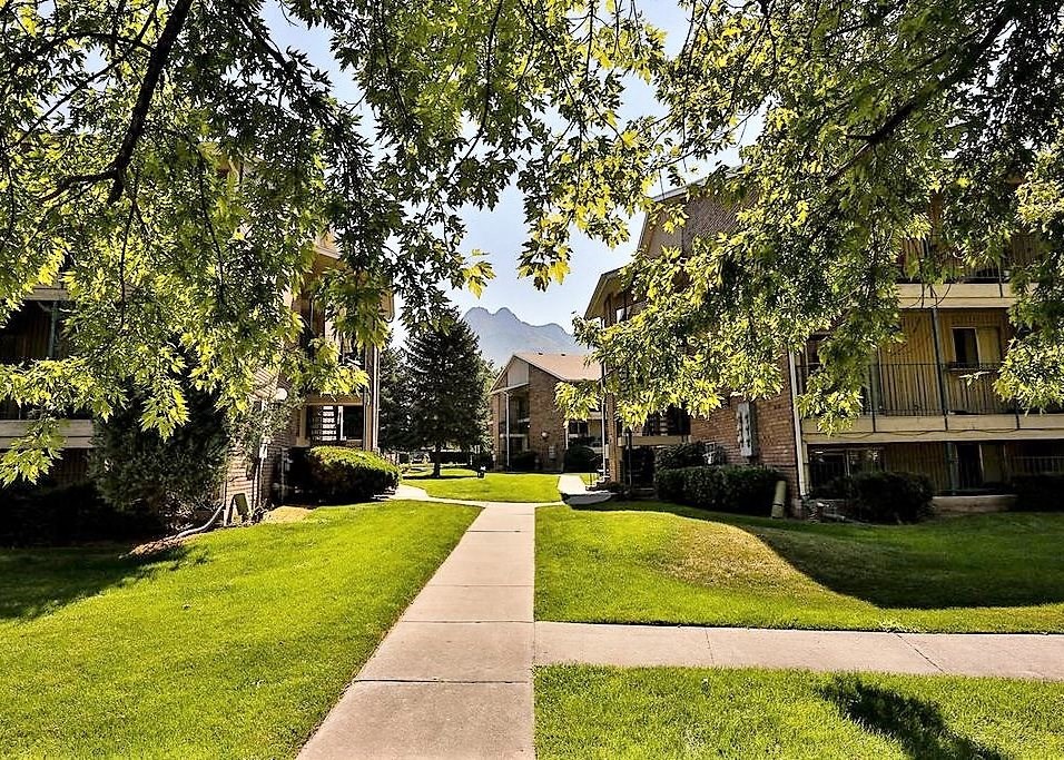 a sidewalk in the middle of a neighborhood with trees