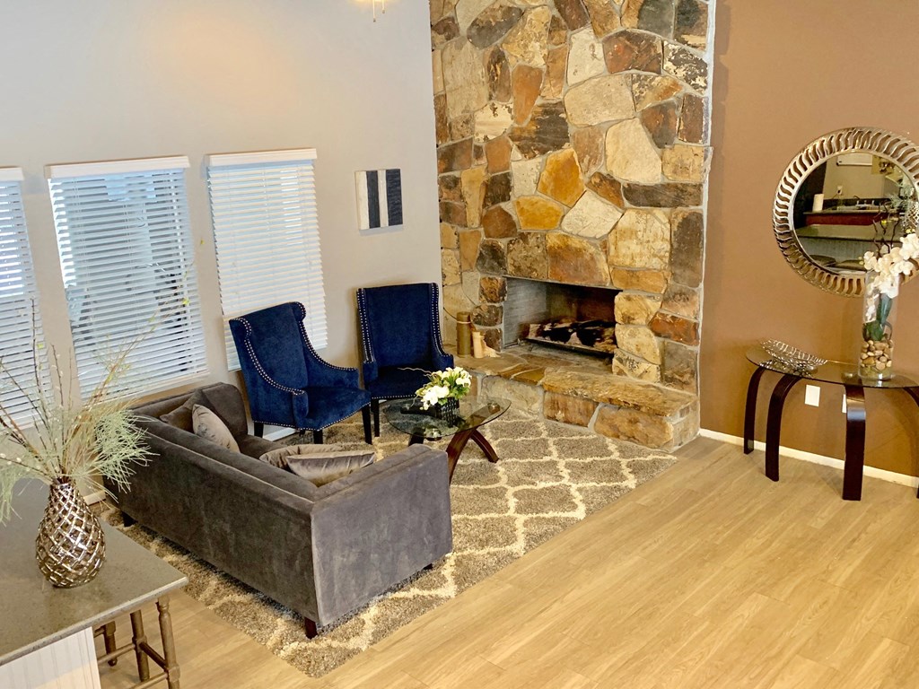 a living room with a stone fireplace and a couch