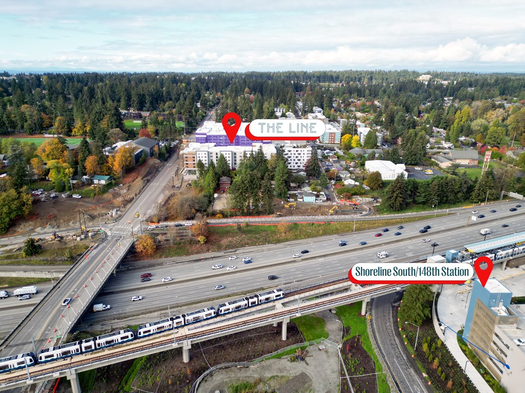 a aerial view of a highway with a sign that reads the line in the background