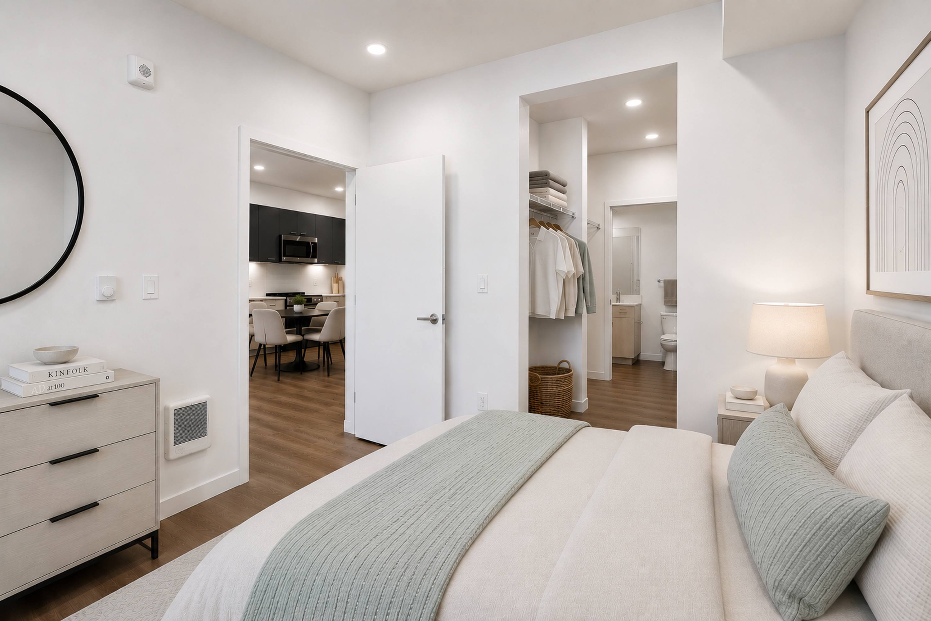 A bedroom with a large bed and a mirror on the wall.