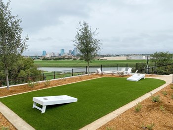 Presidio at River East Outdoor Corn Hole with View of Downtown - Photo Gallery 15