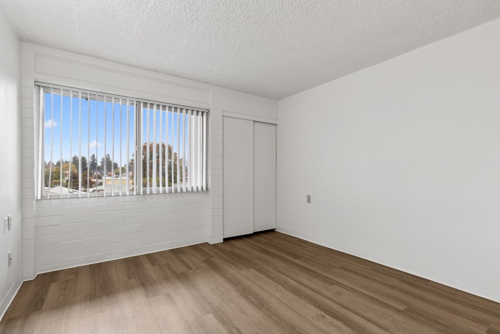 A room with a window overlooking a street.