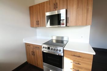 A kitchen with a stove top oven and microwave above it.