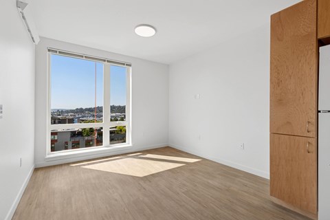 A room with a large window overlooking a cityscape.