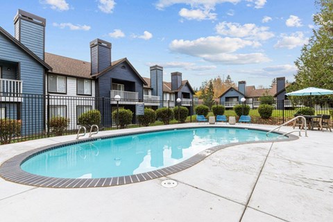 a swimming pool with apartments in the background