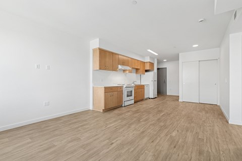 A kitchen area with wooden floors and white walls.