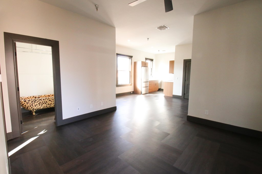 A room with wooden floors and white walls.
