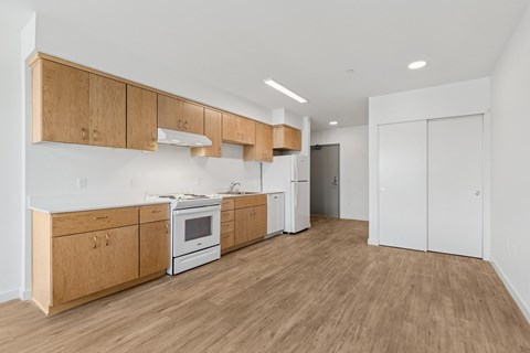 A kitchen with wooden cabinets and white appliances.