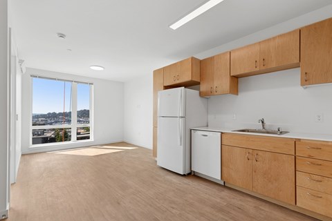 A kitchen with wooden cabinets and a white refrigerator.