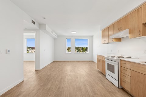 A kitchen with wooden floors and white walls.