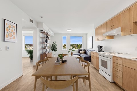 A modern kitchen with a dining table and chairs.