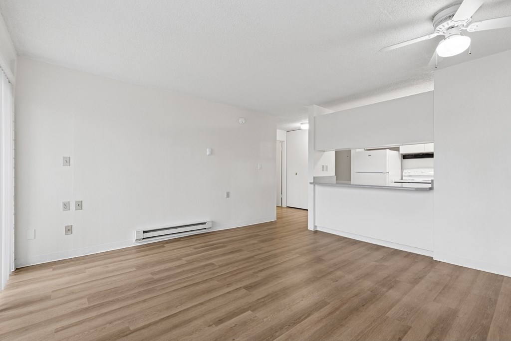 A room with wooden floors and white walls.