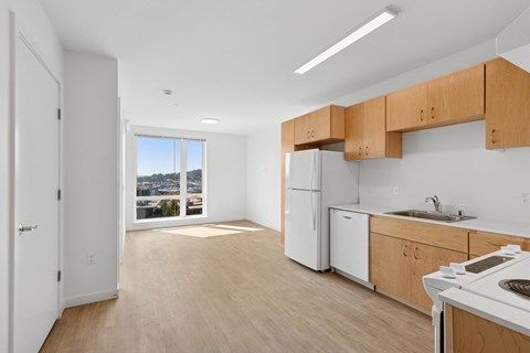 A kitchen with white appliances and wooden cabinets.