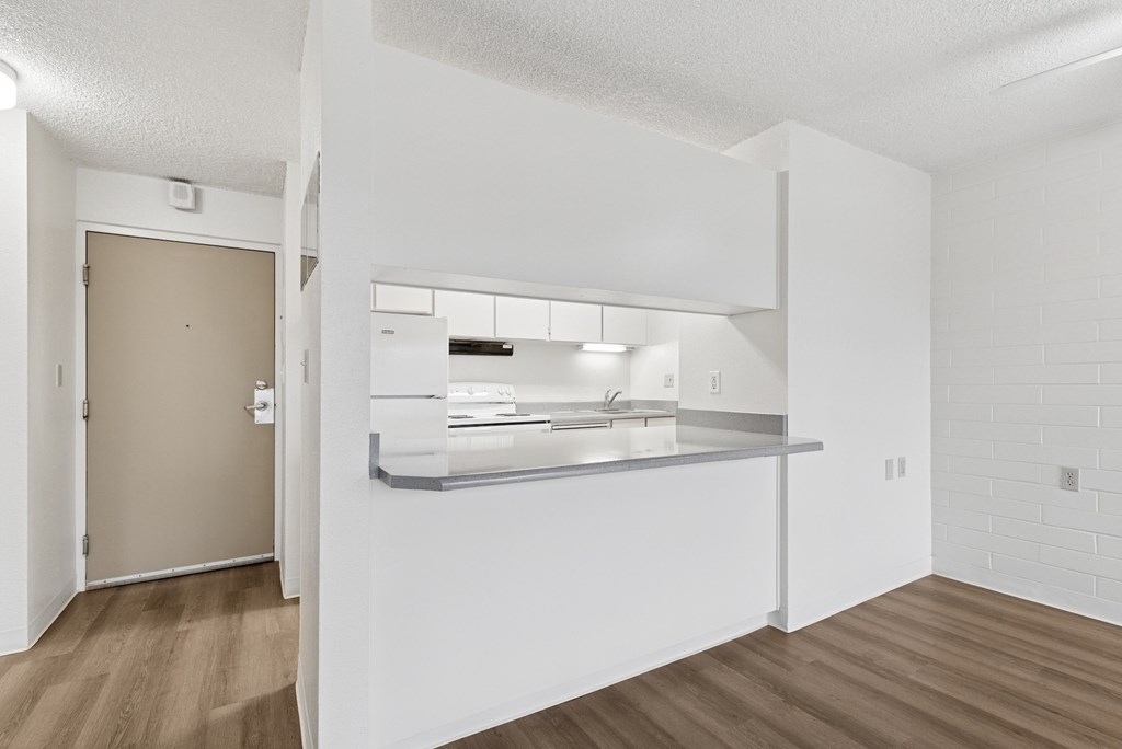 A kitchen with a sink and a counter.