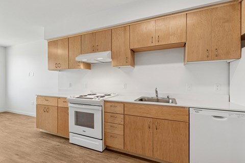 A kitchen with wooden cabinets and white appliances.