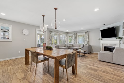 A dining room with a wooden table and chairs.