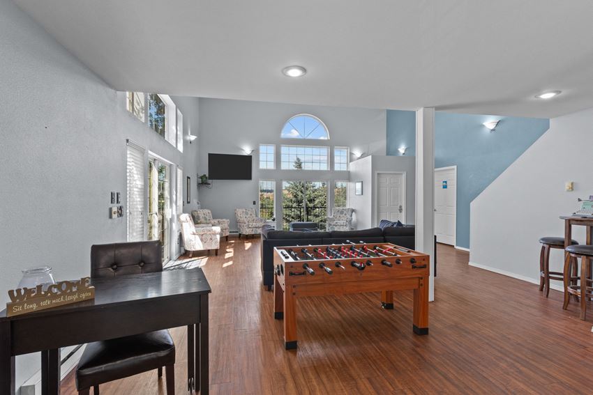 a large living room with a foosball table