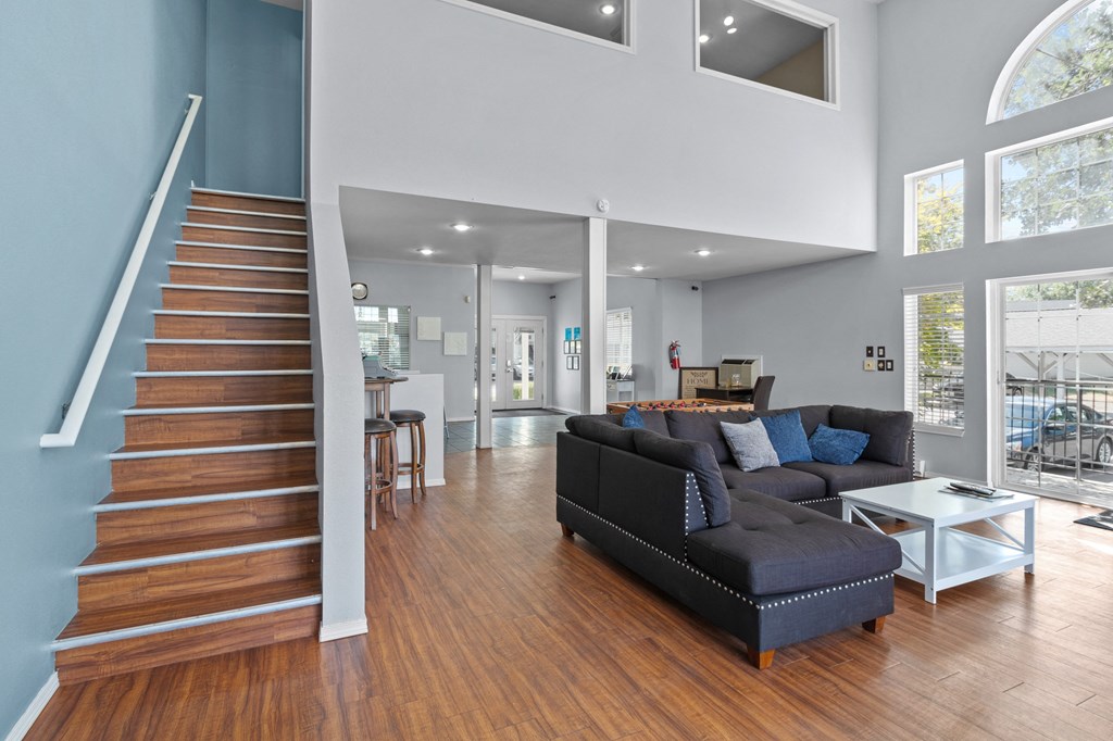 a living room with a staircase and a couch      and a