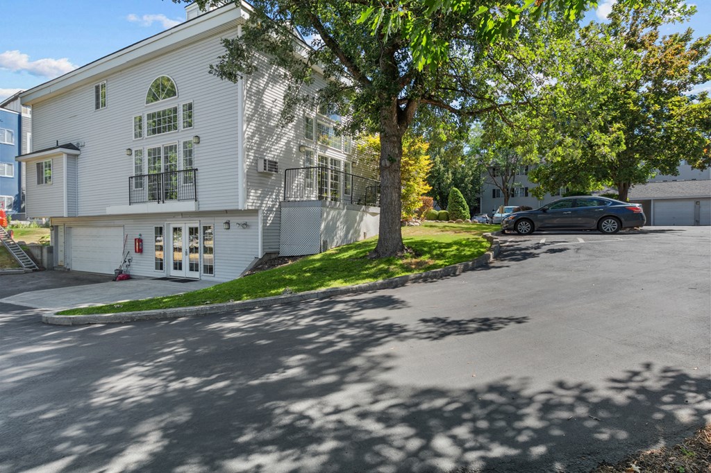 a large white house with a tree in front of it