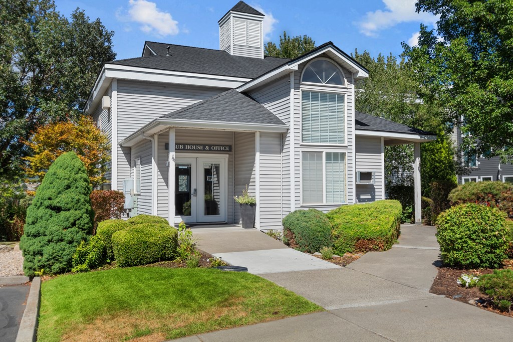 a white house with a sidewalk in front of it