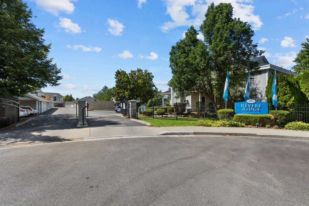 a city street with a sign for the park at the end of the road