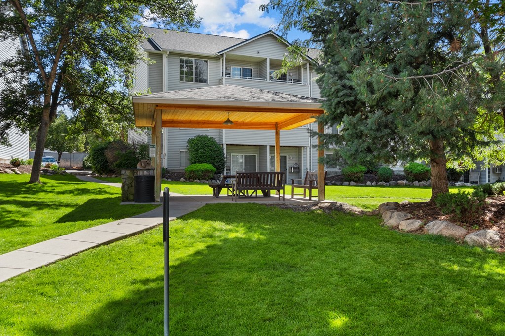 a covered patio in front of a house