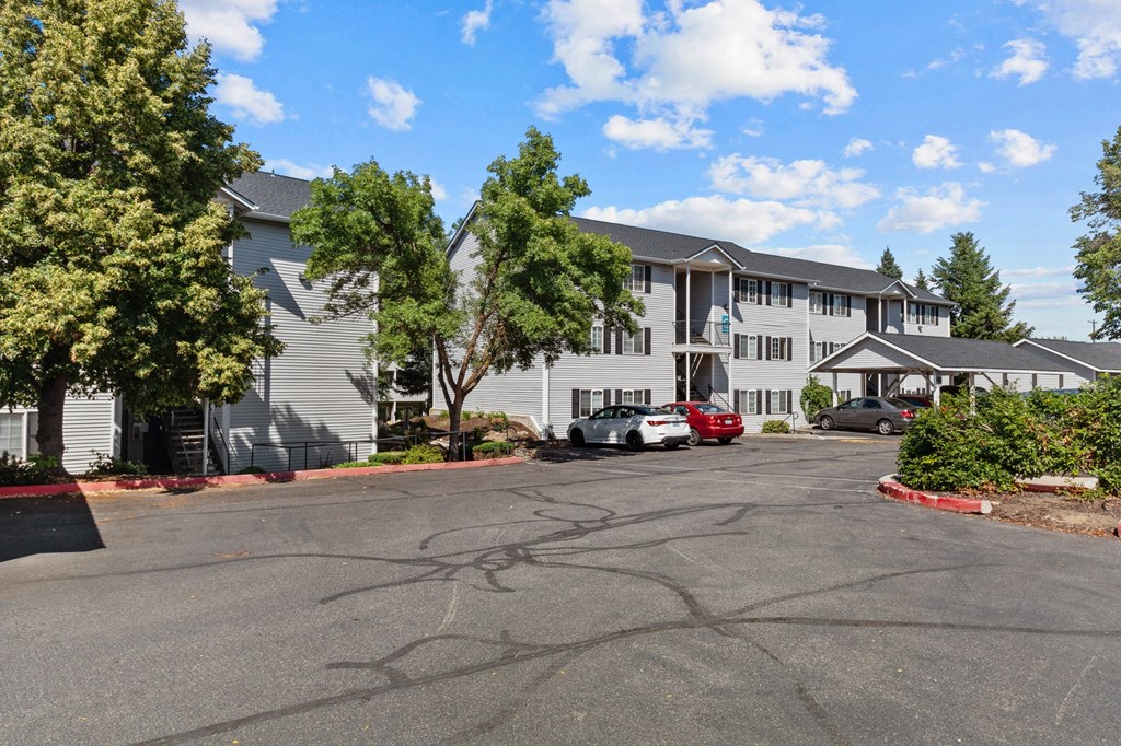 the view of a building with cars parked in front of it